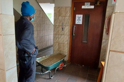 Tradesmen should not put full wheelbarrow of mortar in lift